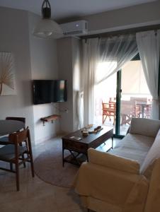 a living room with a couch and a table at Stella's Beach House in Nikiti