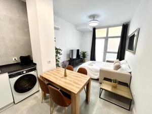 a small apartment with a bed and a table and chairs at Valencia Getaway - Jacuzzi, Space & Comfort in Valencia