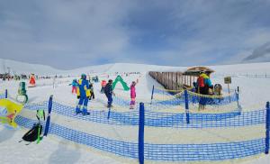 a group of people in the snow at a ski slope at Leiterhütte in Patergassen