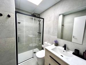 a bathroom with a shower and a toilet and a sink at Valencia Getaway - Jacuzzi, Space & Comfort in Valencia