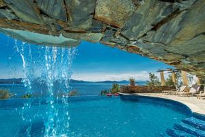 a swimming pool with a water fountain at Pounda Paou in Metókhion