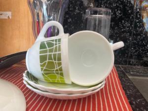 a tea pot sitting on a stack of plates at The Pearl Villa Ahangama in Ahangama