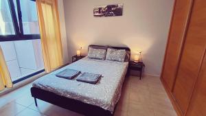 a bedroom with a bed with two pillows on it at Casa Bella Vista - pool - WiFi in Caleta De Fuste +47 photos