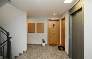 an empty hallway with a door and a plant at Beautiful Apartment In Pineda De Mar in Pineda de Mar +13 photos
