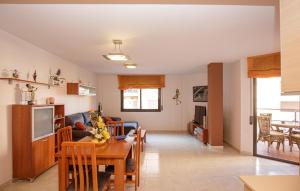 a kitchen and living room with a table and a couch at Beautiful Apartment In Pineda De Mar in Pineda de Mar