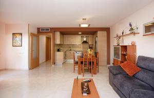 a living room and kitchen with a couch and a table at Beautiful Apartment In Pineda De Mar in Pineda de Mar
