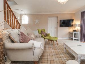 a living room with a couch and a table at Chapel Croft in Skipton