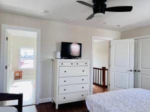 a bedroom with a tv on top of a dresser at Amma's Place in Washington, D.C.