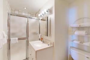a bathroom with a shower and a sink and a toilet at Crystal Beach Lakefront Condo in McCall +17 photos