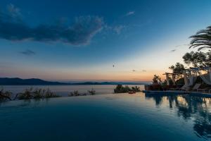 a swimming pool with a view of the water at Pounda Paou in Metókhion