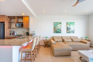 a kitchen and living room with a couch and a table at Cartagena Dreams Luxury Oceanfront Suite wPool 2 in Cartagena de Indias