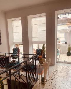 a living room with two chairs and windows at B&B Liberty in Santa Maria Capua Vetere