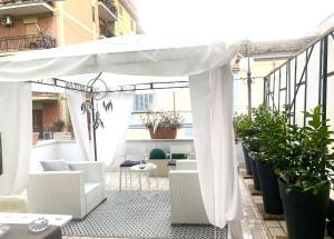 a white canopy on a balcony with plants at B&B Liberty in Santa Maria Capua Vetere