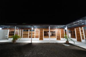 a building with lights in front of it at night at Bay Lodge in La Cruz