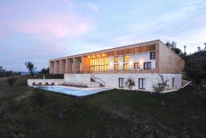 a brick building with a swimming pool in front of it at ViilA Cheia in Cheia