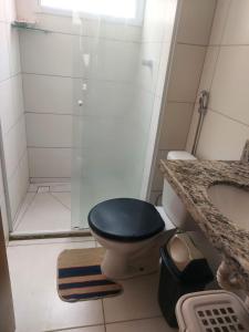 a bathroom with a blue toilet and a shower at apartamento mobiliado à 3km da praia in João Pessoa +4 photos