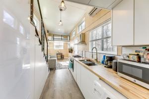 a kitchen with white cabinets and a sink at Hiking and Creek Manor Tiny Home in Forest Retreat in Manor