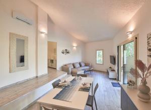 a living room with a table and a couch at Villa Corallo in Costa Rei