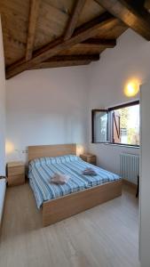 a bedroom with a bed in a room with wooden ceilings at Ca' nel Bosco in Madonna del Sasso