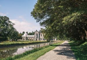 a large building on the side of a river at The Coach House, 3 Beds in Bray