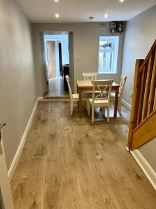 a dining room with a wooden table and chairs at The Coach House, 3 Beds in Bray