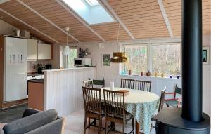 a kitchen and dining room with a table and chairs at Holiday Home Grenaa 24 in Fuglsang