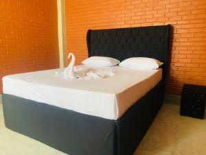 Postel nebo postele na pokoji v ubytování Resolve Garden Hotel