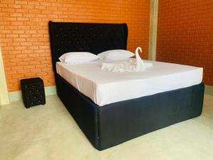 Postel nebo postele na pokoji v ubytování Resolve Garden Hotel