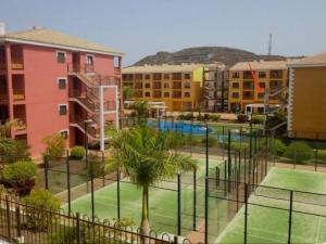 a tennis court in front of some buildings at SAFA 2 in Palm-Mar