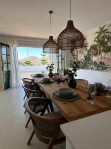 a dining room with a wooden table and chairs at Finca El Pedregal - Suite Olivo in Haría