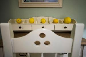 a white table with fruit on top of it at Pounda Paou in Metókhion