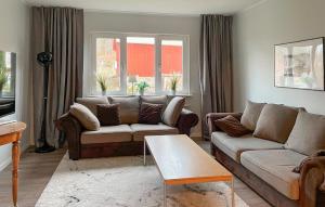 a living room with a couch and a table at Hällgården in Vena +17 photos