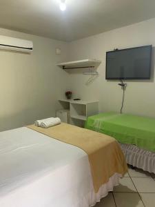 Ένα ή περισσότερα κρεβάτια σε δωμάτιο στο Pousada Vento Norte