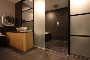 a bathroom with a shower and a sink at Hotel Cacao in Incheon