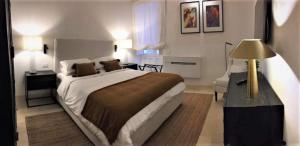 a bedroom with a large bed and a desk with a lamp at Croce Luxury Apartment with Air Conditioning, Wi-Fi n0975 in Siracusa