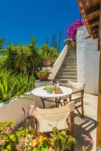 a table and chairs on a patio with stairs at Pounda Paou in Metókhion
