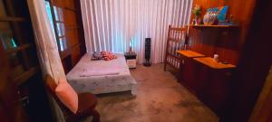 a small bedroom with a bed and a window at Floresta Zen - Pousada Xamanica in Manaus