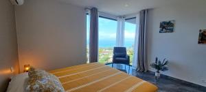 a bedroom with a bed with a view of the ocean at TAHITI - Villa Green M in Punaauia +27 photos