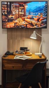 a desk with a monitor on a wall at Hotel Protea Bolesławiec in Bolesławiec +98 photos