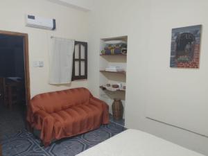 ein Wohnzimmer mit einer braunen Couch in einem Zimmer in der Unterkunft Hosteria sol naciente in Cafayate + 18 Fotos