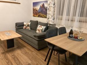a living room with a couch and a table at Appartment Elfi in Uttendorf