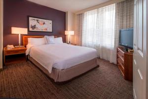 a hotel room with a bed and a flat screen tv at Residence Inn Alexandria Old Town/Duke Street in Alexandria +28 photos