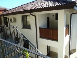 a house with a balcony and a staircase at Cloudbase Guesthouse in Sopot