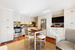 a kitchen with white cabinets and a table and chairs at Mariner's Watch 4236 in Kiawah Island +14 photos