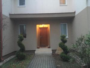 a house with a brown door with a light on it at A2 Apartman in Sopron