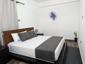 a bedroom with a bed and a fan at A 7 minutos del Aeropuerto SDQ, Moderno y Compacto Apartamento in Boca Chica