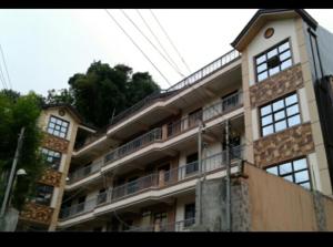a large building with a clock tower on top of it at 017 Baguio Transient in Baguio