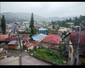 a view of a city with roofs of buildings at 017 Baguio Transient in Baguio