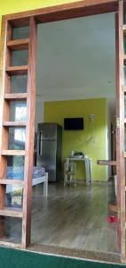 a room with a kitchen and a living room at CHALÉ LUZIMAREs 01 in Ilhéus