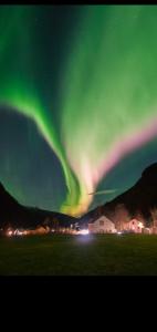 an aurora in the sky over a field at Modern villa for rent in Lavangen